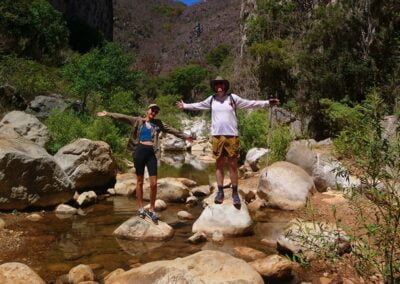 Hike & Swim @ Iconic Apoala Waterfalls 3 Two people standing on the top of big stones in the river