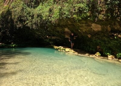 Hike & Swim @ Iconic Apoala Waterfalls 8 A person walks near calm lagoon
