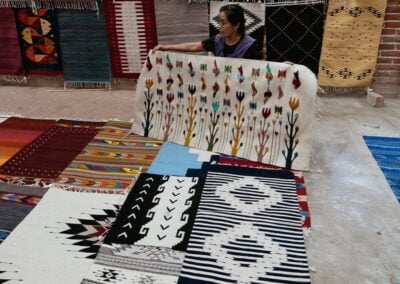A person holding Teotitlan rugs