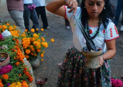 a woman holding a pot with a long stick