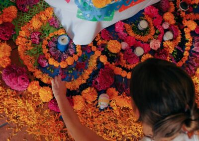a person touching flowers on a rug