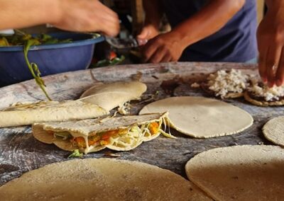 A group of people making tortilla dish