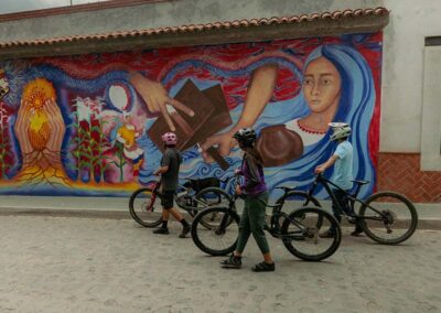 Three bikers looking at a mural wall