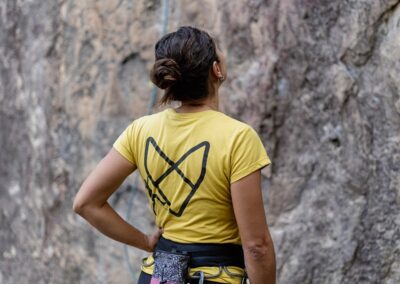 A person standing in front of a rock with safety rope