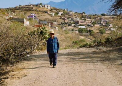 A man with hat walking in a path