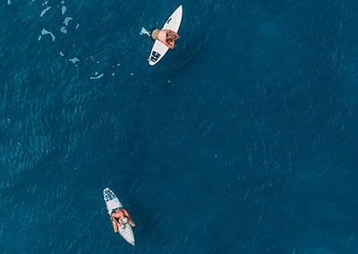Two people on of surfboards in the ocean