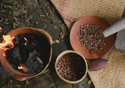 Charcoal burning in a fire pottery and cocoa beans on a pottery plate