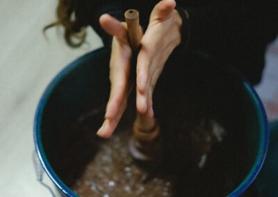 Hands of a person making chocolate in the big bowl