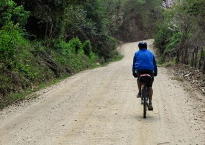 A person from behind riding a bike