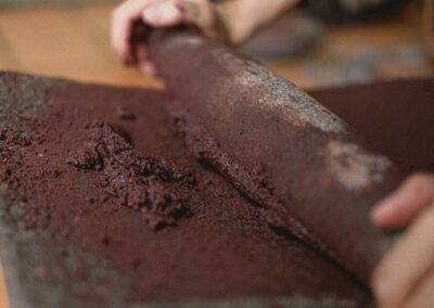 Hands grinding chocolate beans
