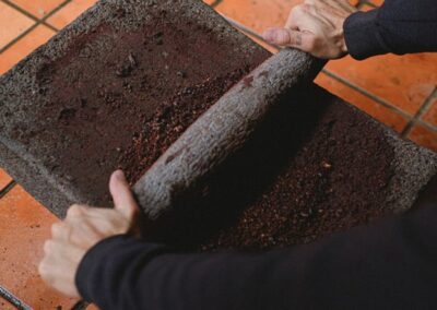 Hands from above grinding chocolate beans