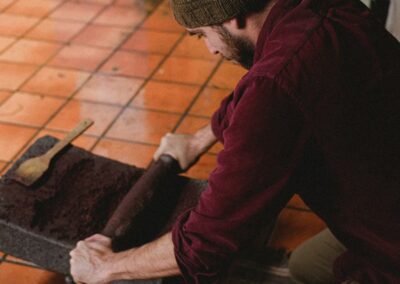 A person grinding chocolate beans