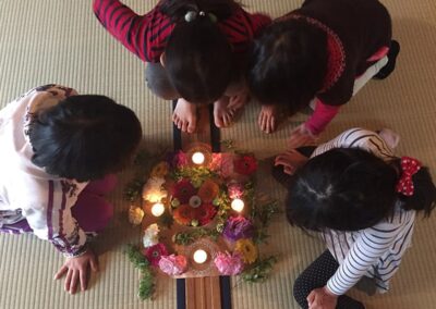 A group of kids surrounding the equipments for Cacao Ceremony