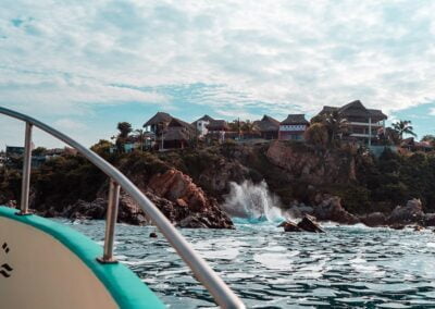 The buildings are on cliffs with waves crashing below