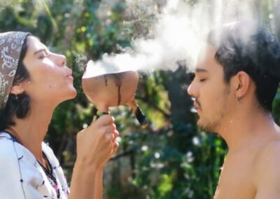 a man and woman blowing out steam from a cup