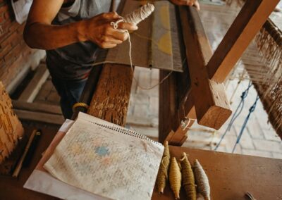 A person weaves cloth