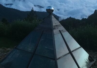 A triangular greenhouse at a height with natural views