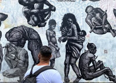 A man looking at murals