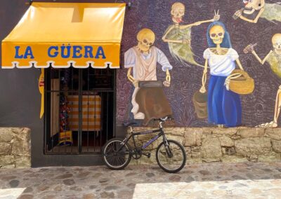 A bike placed in front of mural