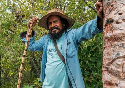 a man in a hat holding a stick