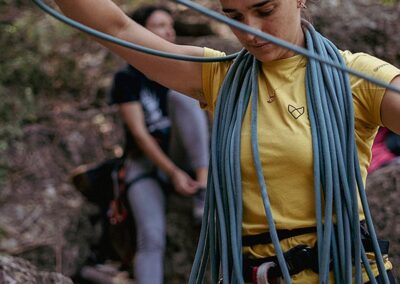 A girl using rope preparing to rock climbing