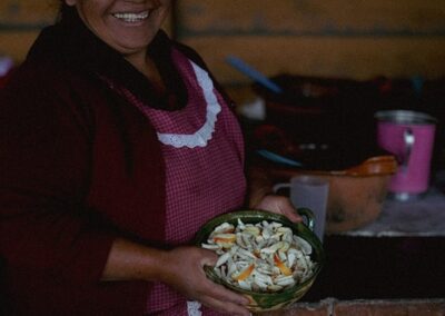 a woman holding a bowl of food