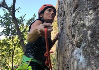 A woman climbing the rocks