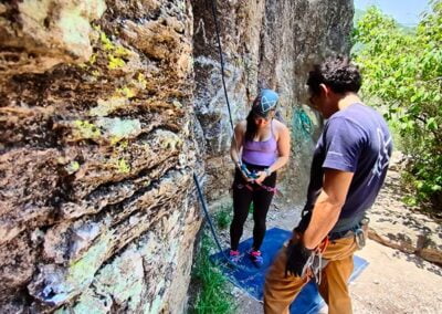 A woman preparing herself before rock climbing